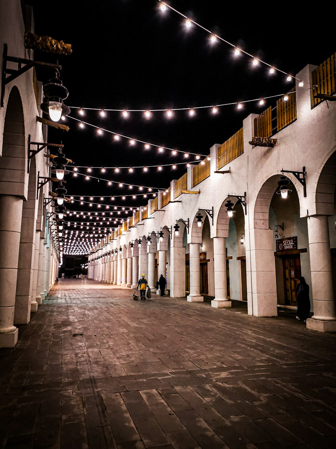 Cobblestone street in the old town of Montevideo at night with warm streetlights